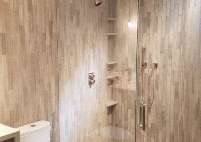 Modern bathroom with a walk-in shower and a toilet.