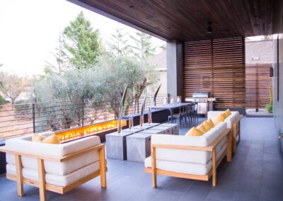 Modern outdoor patio with cozy seating and dining area.